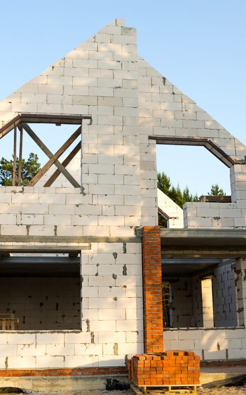 The object of unfinished construction is a future house made of a porous concrete block